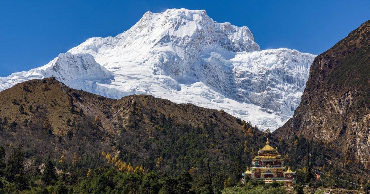Manaslu trekking view with moutains and temple.